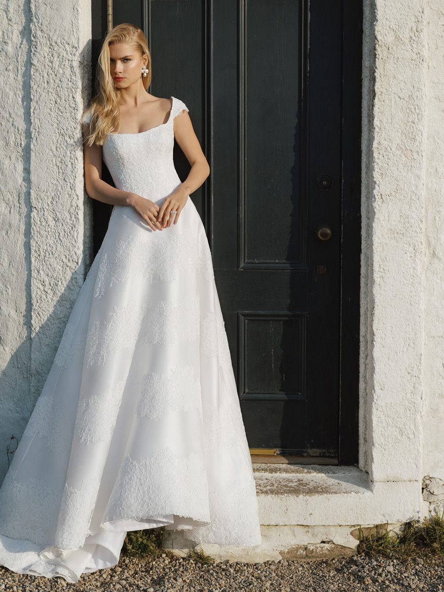 Love Couture Bridal Wedding Dresses Woman modeling a refined, couture Wedding Dresses.