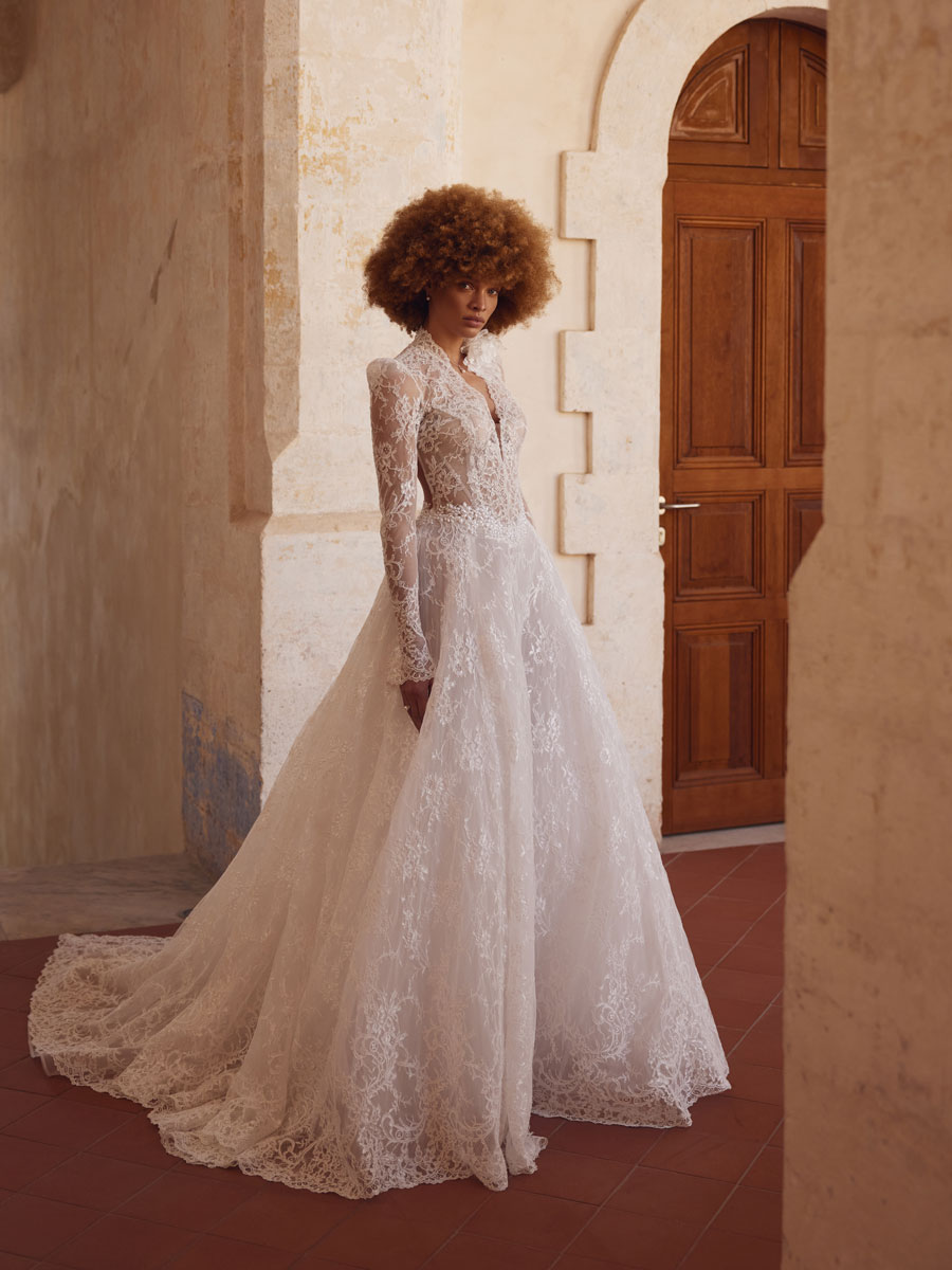 Love Couture Bridal Wedding Dresses. White wedding dresses with floral lace near ancient stone ruins.