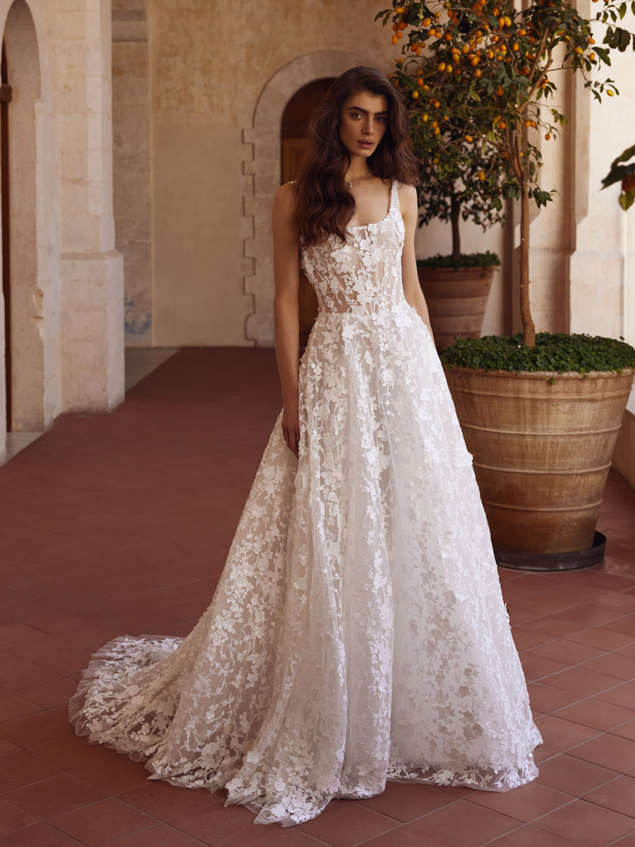 Love Couture Bridal Wedding Dresses. Elegant lace wedding dresses on a contemplative bride at ruins.