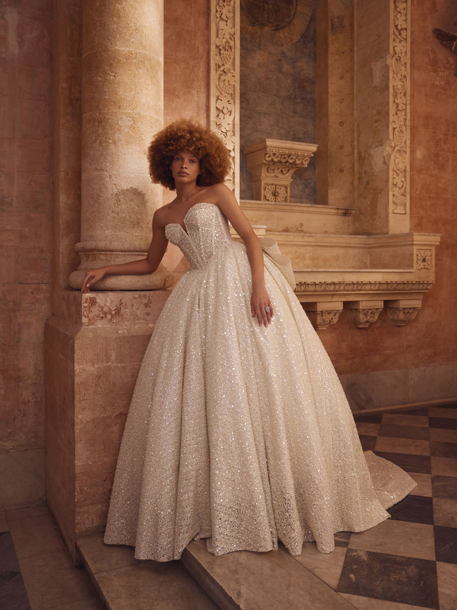 Love Couture Bridal Wedding Dresses. White lace wedding dresses worn by a woman at ancient ruins.