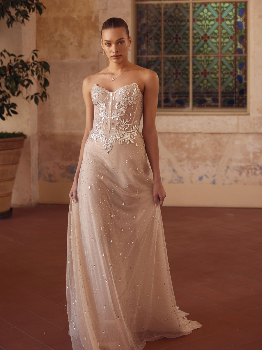 Love Couture Bridal Bridal lace wedding dresses worn by a woman at historical ruins.