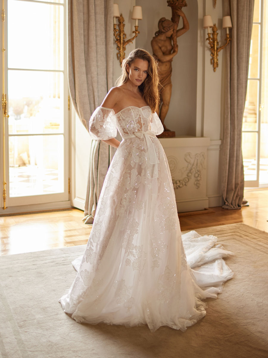 Woman in elegant Love Couture Bridal Wedding Dresses.