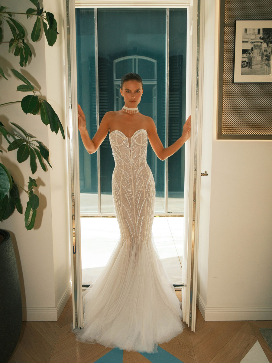 Woman in an opulent, princess-style Love Couture Bridal Wedding Dresses.