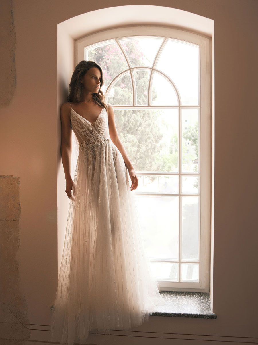 Lady in a timeless, high-fashion Love Couture Bridal Wedding Dresses.