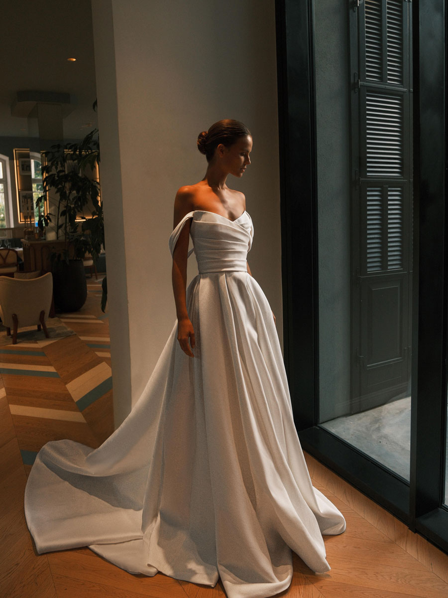 Lady in a sophisticated, detailed Love Couture Bridal Wedding Dresses.