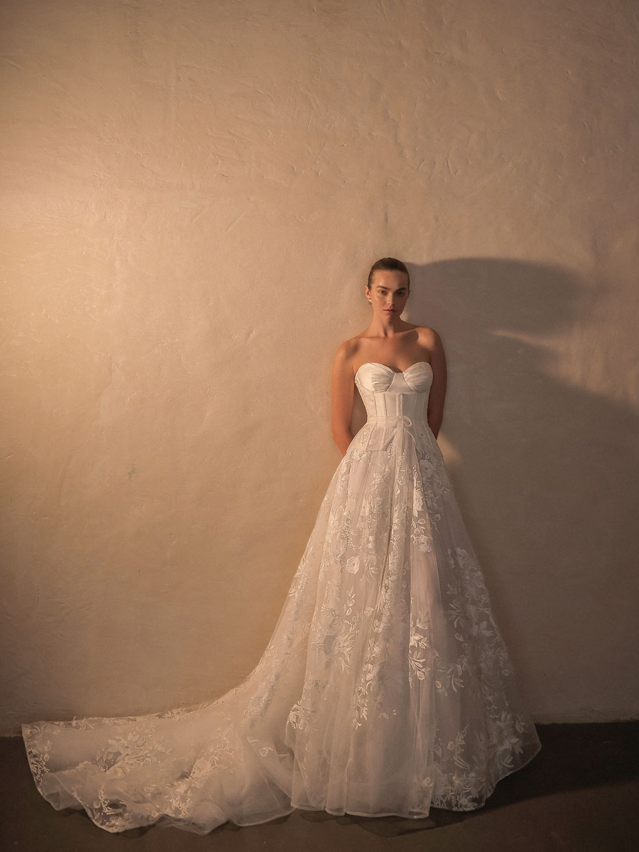 Lady in a timeless, floral lace Love Couture Bridal Wedding Dresses.