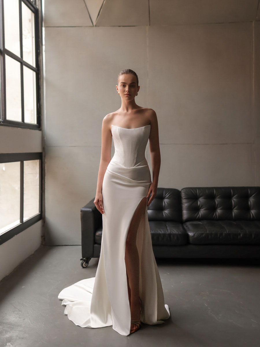 Woman modeling an ornate, couture Love Couture Bridal Wedding Dresses.